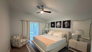 A bedroom with a bed, nightstands, a ceiling fan, and artwork on the wall. - Welcome to our beautiful 3-bedroom, 2-bath home in the heart of Marco Island! (Marco Island)