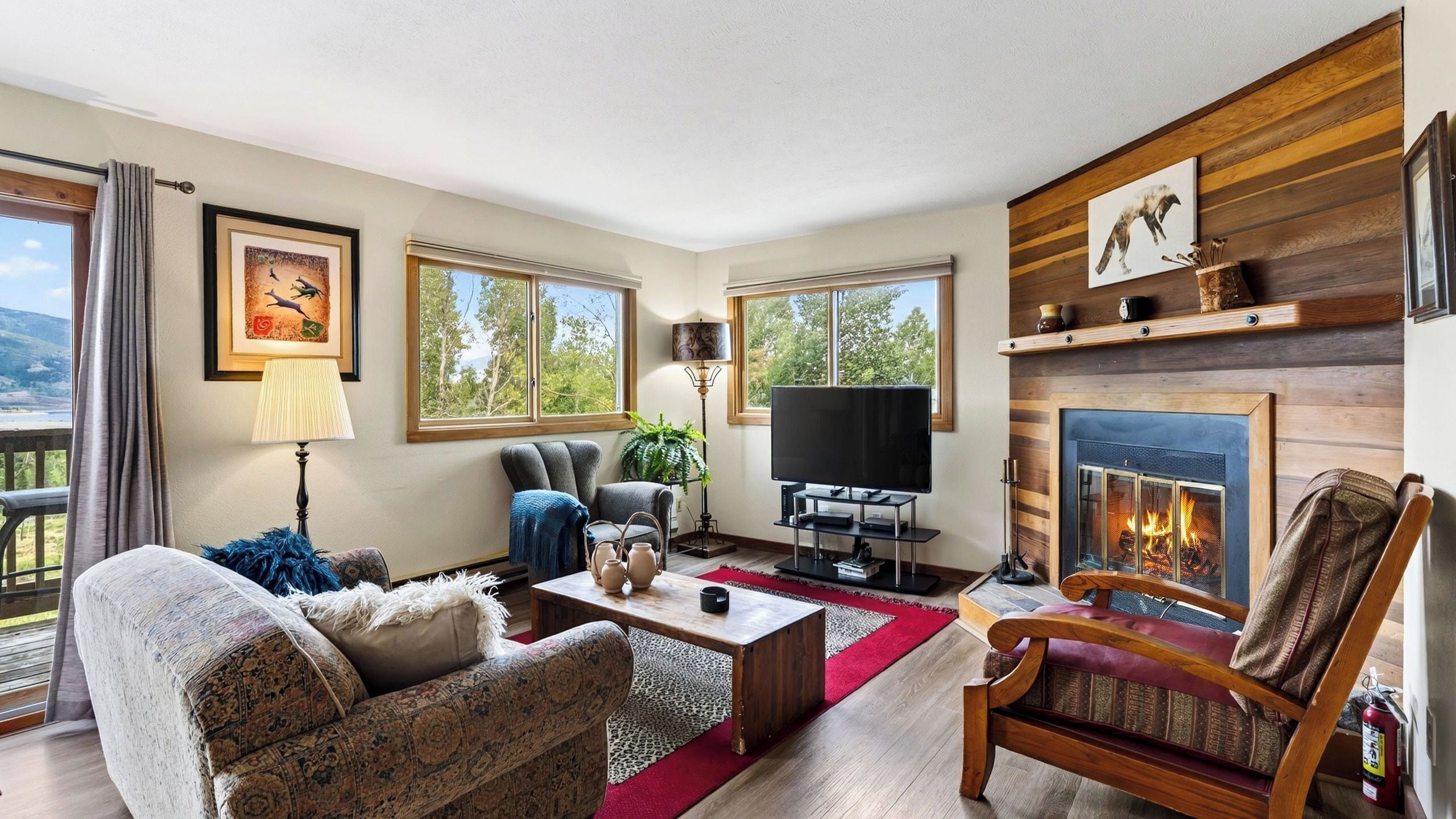 A living room with a fireplace, a television, and a sofa.