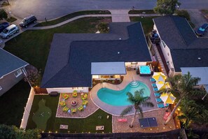 A residential property with a swimming pool, outdoor seating, and a fire pit. - Pool •  Hot Tub•  Putt Putt • Game Room •  Karaoke (Largo)