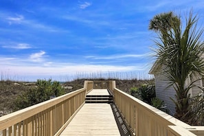 A wooden boardwalk leading to a beach with a clear sky. - A Place at the Beach V - A307 (Myrtle Beach)