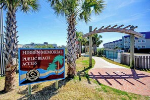 A sign for Hibben Memorial Public Beach Access with a clear pathway leading to a wooden archway. - Arcadian Dunes 02-207 (Myrtle Beach)