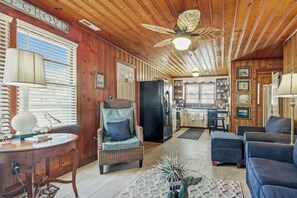 A cozy cabin interior with a dining area, a kitchen, and a living room. - Cozy Beach House 314 (North Myrtle Beach)