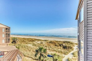 A beachfront property with a pool, a beach view, and a path leading to the beach. - Atlantic Escape Oceanfront Condo (North Myrtle Beach)