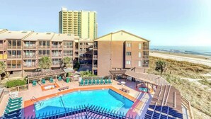 A hotel with a pool, beach view, and multiple balconies. - Atlantic Escape Oceanfront Condo (North Myrtle Beach)
