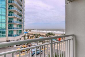 A high-rise building with a balcony overlooking a beach and ocean. - Sandy Beach Resort 304 (Myrtle Beach)