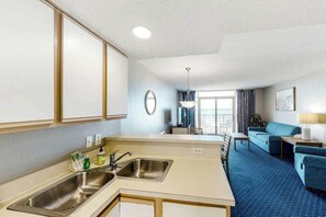 A hotel room with a kitchenette, a dining area, and a living space. - Bay Watch Resort 0314 (North Myrtle Beach)