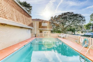 A swimming pool with a brick wall on one side and a wooden fence on the other. - Porcher Villas Unit 7 (Myrtle Beach)