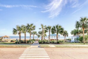 A beachfront promenade with palm trees, a gazebo, and a view of the ocean. - Porcher Villas Unit 7 (Myrtle Beach)