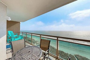 A balcony with a table and chairs, overlooking a coastal view. - Bahama Sands Unit 0806 (North Myrtle Beach)