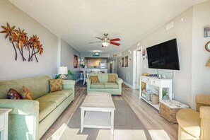 A living room with a sofa, coffee table, and a flat-screen TV. - Bahama Sands Unit 0807 (North Myrtle Beach)