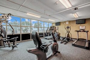 A gym with cardio machines, weight equipment, and a TV on the wall. - Bahama Sands Unit 0905 (North Myrtle Beach)