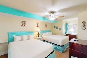 A hotel room with two beds, a ceiling fan, and artwork on the walls. - Bahama Sands 0906 - Dolphin's Delight (North Myrtle Beach)
