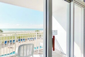 A balcony with a view of a beach and pool area. - Bay Watch Resort 0206 (North Myrtle Beach)