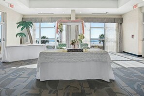 A room with a view of the ocean, a table with a white tablecloth, and a sign that reads 'Love Never Fails'. - Bay Watch Resort 0412 (North Myrtle Beach)