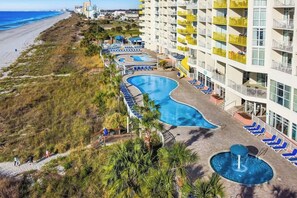 A resort with a swimming pool, beach access, and a multi-story building with balconies. - Bay Watch Resort 0301 Oceanview (North Myrtle Beach)