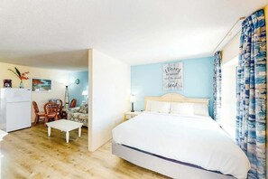 A bedroom with a bed, a desk, and a chair. - Bay Watch Resort 0531 (North Myrtle Beach)
