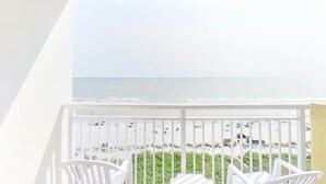 A balcony with white railings overlooking a beach. - Bay Watch Resort 0807 (North Myrtle Beach)