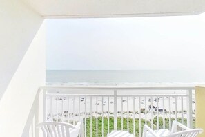 A balcony with white railings overlooking a beach. - Bay Watch Resort 0807 (North Myrtle Beach)