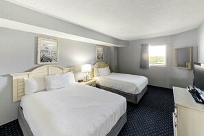 A hotel room with two beds, a desk, a TV, and artwork on the walls. - Bay Watch Resort 0814 (North Myrtle Beach)