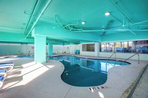 An indoor swimming pool with clear water, a 3 FT 6 IN depth marking, and a view of the outside through large windows. - Bay Watch Resort 1017 (North Myrtle Beach)