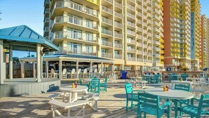 A resort with outdoor seating and a pool area. - Bay Watch Resort 1422 (North Myrtle Beach)