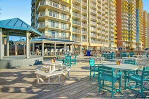 A resort with outdoor seating and a pool area. - Bay Watch Resort 1422 (North Myrtle Beach)