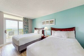 A hotel room with two beds, a balcony, and a view of the ocean. - Bay Watch Resort 1215 (North Myrtle Beach)