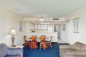 A compact living space with a dining area, kitchenette, and a sofa. - Bay Watch Resort 1417 (North Myrtle Beach)
