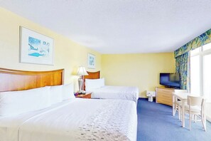 A hotel room with two beds, a desk, a television, and artwork on the walls. - Bay Watch Resort 1701 (North Myrtle Beach)