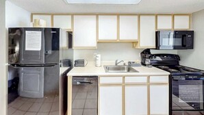 A compact kitchen with a refrigerator, microwave, stove, and dishwasher. - Bay Watch Resort 1704 (North Myrtle Beach)