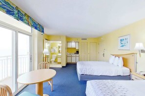 A hotel room with two beds, a dining table, a kitchenette, and a bathroom. - Bay Watch Resort 1801 (North Myrtle Beach)