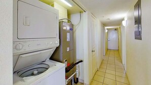 A laundry room with a washing machine, dryer, and utility room. - Bay Watch Resort 1815 (North Myrtle Beach)