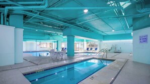 An indoor swimming pool with a sign indicating shallow water and no diving allowed. - Bay Watch Resort 1920 (North Myrtle Beach)