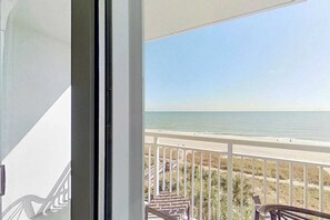 A balcony with a view of the ocean and beach. - Camelot by the Sea 0516 (Myrtle Beach)