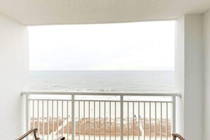 A balcony with a white railing overlooking a beach. - Camelot by the Sea 1102 (Myrtle Beach)