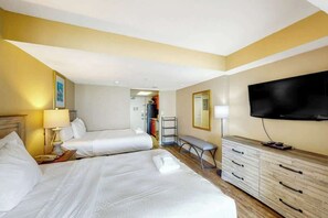 A hotel room with two beds, a TV, a desk, and a wardrobe. - Camelot by the Sea 1103 (Myrtle Beach)