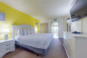 A bedroom with a bed, nightstand, dresser, and a television. - Camelot by the Sea 1216 (Myrtle Beach)