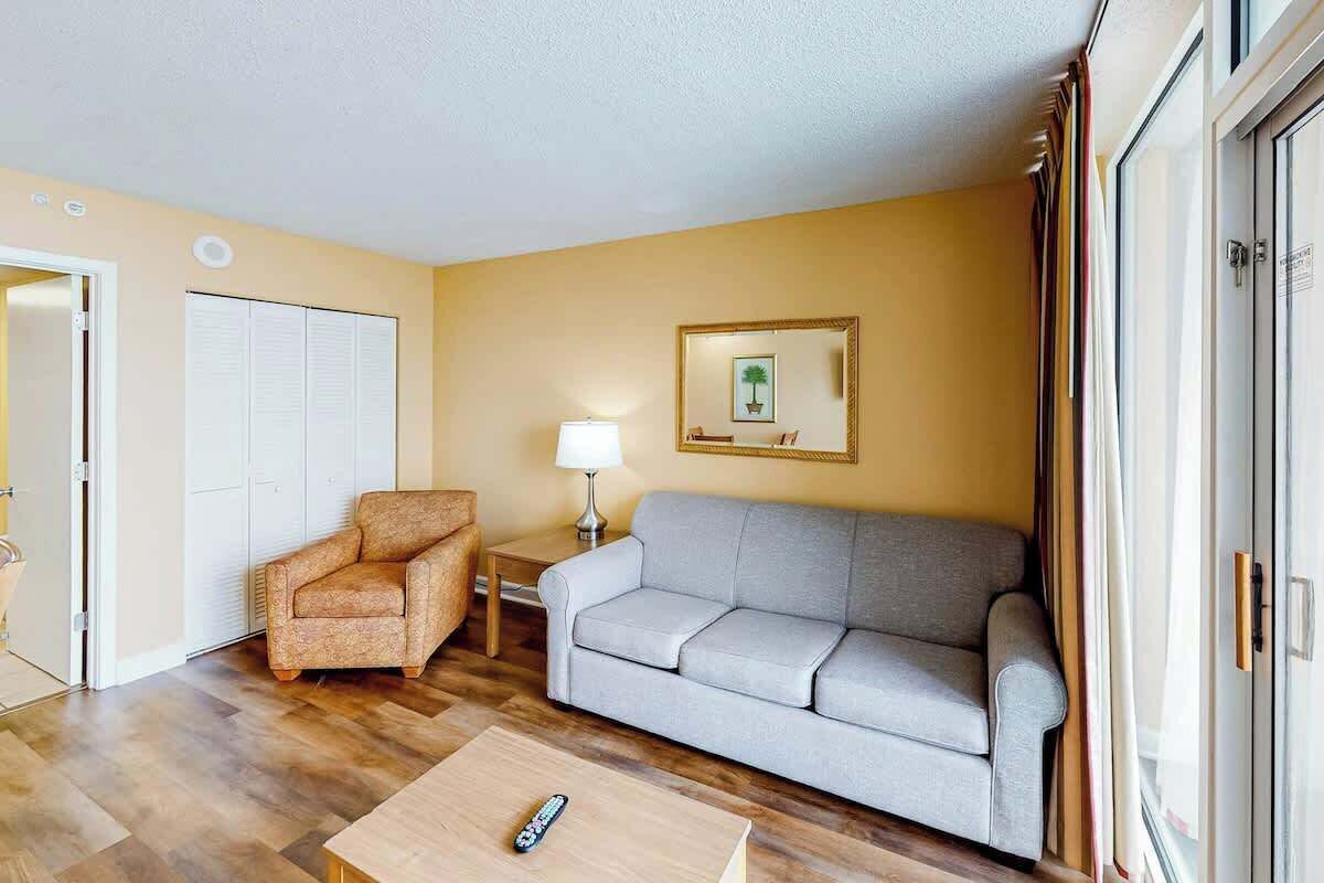 Un salon avec un canapé, un fauteuil et une table basse.
