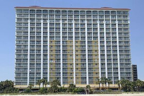 A high-rise hotel with multiple floors, balconies, and a flat roof. - Camelot by the Sea 1603 (Myrtle Beach)