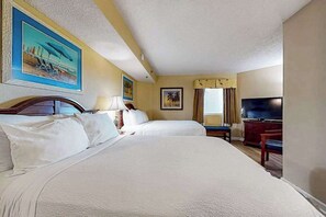 A hotel room with two beds, a television, and artwork on the walls. - Carolinian Beach Resort 1232 (Myrtle Beach)