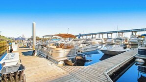 A marina with boats docked, a wooden pier, and a clear blue sky. - Harbourgate Unit 0320 (North Myrtle Beach)