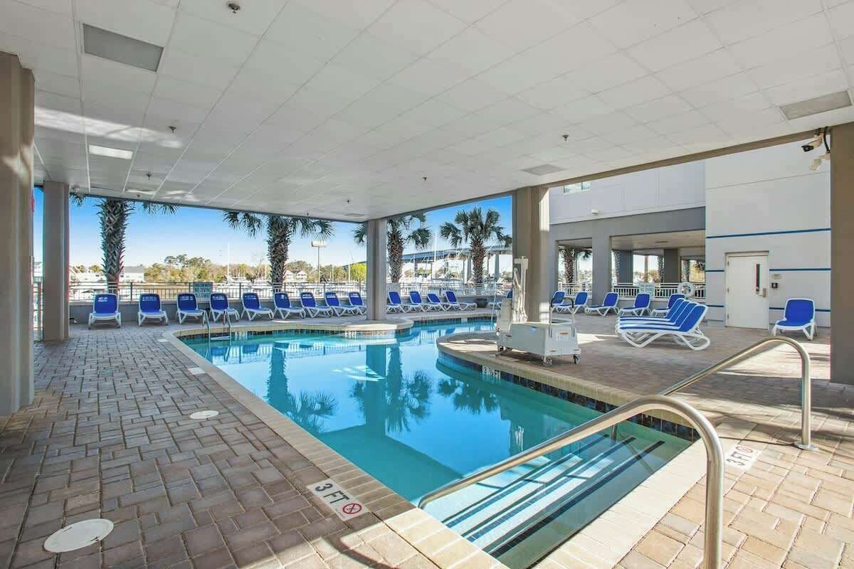 A pool area with lounge chairs and a clear view of the surrounding landscape.