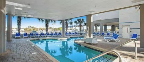 A pool area with lounge chairs and a clear view of the surrounding landscape.