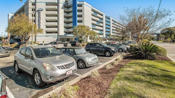 A multi-story hotel with a parking lot in front. - Harbourgate Unit 0626 (North Myrtle Beach)