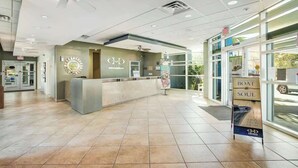 A hotel reception area with a reception desk, a clock, and a signboard advertising a boat and soul experience. - Harbourgate Unit 0626 (North Myrtle Beach)