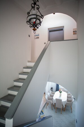 A staircase leading to a dining area with a white table and chairs. - 4-BR Sea-View Villa with Pool near Opatija (Veprinac)