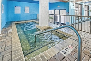 A hot tub area with clear water, a metal safety rail, and a 'No Diving' sign. - Ocean Park Resort 1224 (Myrtle Beach)