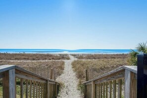 A wooden pathway leading to a beach with a clear sky. - The Patricia Grand 1226 (Myrtle Beach)