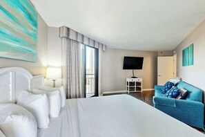 A hotel room with a bed, a sofa, a television, and a window with curtains. - The Patricia Grand 1238 (Myrtle Beach)