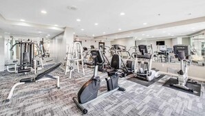 A gym with various exercise equipment, including treadmills and weight machines, and a carpeted floor. - The Patricia Grand 0628 (Myrtle Beach)